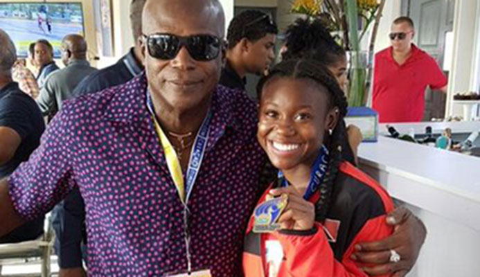 Hasely Crawford, Olympic 100 metres gold medallist, congratulates double gold medalist Khalifa St Fort at the Flow Carifta Games in Curacao, yesterday.