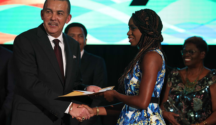 BONUS: Paralympian Nyoshia Cain, right, is presented with her medal bonus by President of the Republic His Excellency Anthony Carmona last Thursday at the TTOC Annual Awards held at the Hyatt Regency Hotel, Port of Spain.