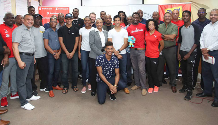 A group of national athletes and officials pose for a photo at the Olympic House, Port of Spain yesterday, during the ceremonial send-off for the TT Commonwealth Games contingent yesterday.