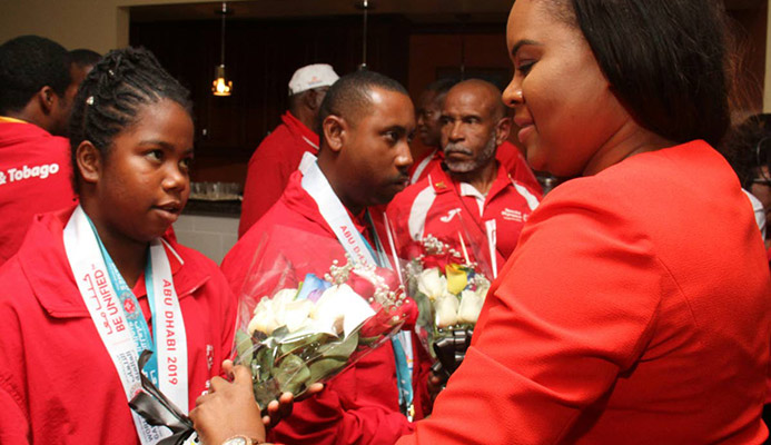 Sports Minister Shamfa Cudjoe (right) meets a member of the Special Olympics TT team during yesterday’s reception at the VIP Lounge, Piarco International Airport.