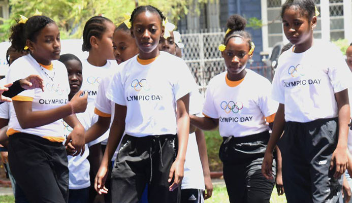 A young gymnast has the attention of other children at Olympic Day 2019 at Lord Harris Square, Port of Spain, on Friday. PHOTOS BY KERWIN PIERRE