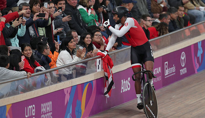 Njisane Phillip greets spectators after winning with teammates Keron Bramble and Paul Nicholas the gold medal in the cycling track men's team sprint final at the Pan American Games in Lima, Peru on Thursday. (AP)