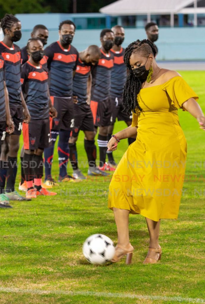 Sports Minister Shamfa Cudjoe kicks the ball ahead of an exhibition game between Bethel United FC and Canaan/1976 FC Phoenix at the newly reopened Dwight Yorke Stadium in Bacolet on Saturday. PHOTOS BY DAVID REID -