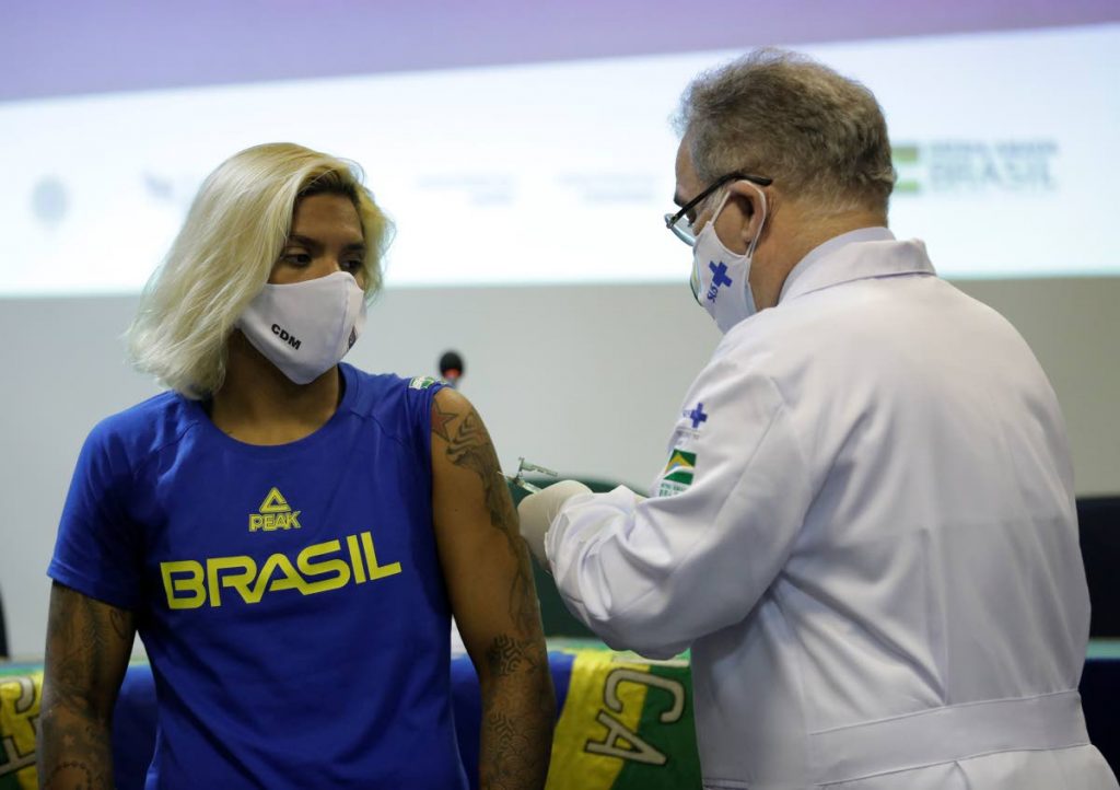 Brazilian swimmer Marcela Cunha (left) gets a shot of the Pfizer vaccine for covid19 from Health Minister Marcelo Queiroga at Urca military base in Rio de Janeiro, Brazil, on Friday. (AP PHOTO) -