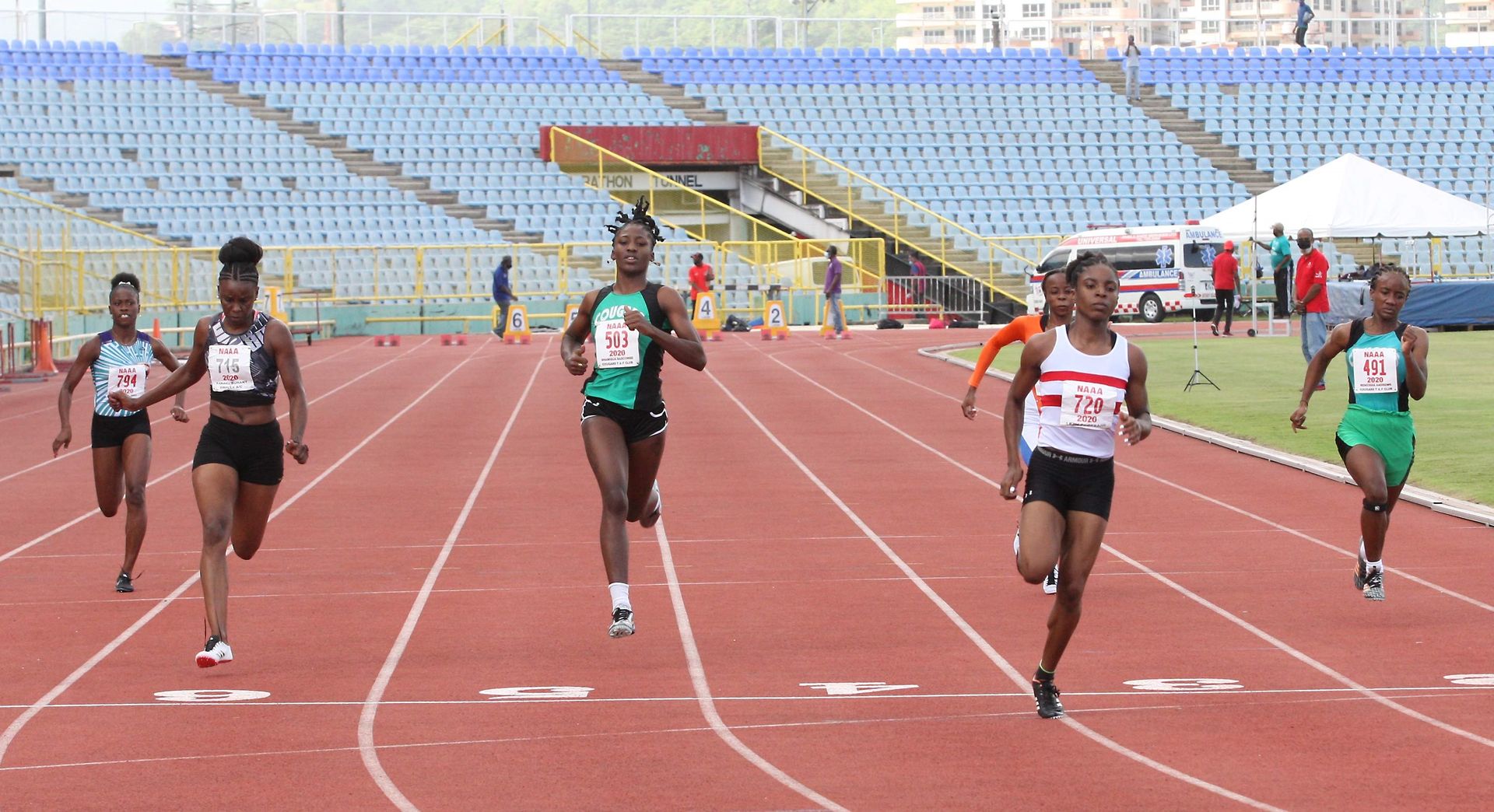 Leah Bertrand of Simplex, fourth from left, eases over the line to win the women's 100 metres with a time of 11.52 seconds ahead of second-place Kamaria Durant also of Simplex (11.90), second from left, and third-placed Shaniqua Bascombe (Cougars), third from left, in 11.97 at the Olympic Trials hosted by the NAAATT at the Hasely Crawford Stadium in Port-of-Spain yesterday.  Anthony Harris