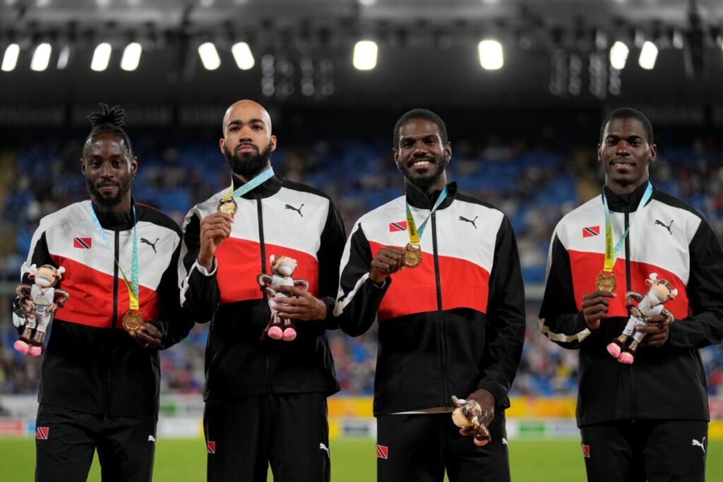 SUPERB RUN: Team TT poses on the podium after winning the gold medal in the Men's 4 x 400 meters relay during the athletics competition in the Alexander Stadium at the Commonwealth Games in Birmingham, England, on Sunday. - Alastair Grant (via newsday.co.tt)
