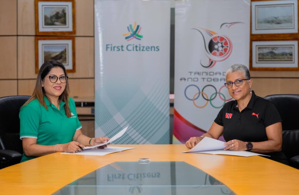 Neela Kissoon, group deputy CEO (designate) at First Citizens, left, and TTOC president Diane Henderson countersign an agreement in solidarity of First Citizens commitment to sport and community. - courtesy First Citizens (Image obtained at newsday.co.tt)