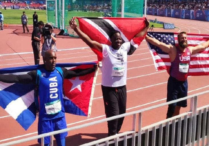 GOLDEN!: Trinidad and Tobago’s Akeem Stewart, centre, celebrates his victory in the men’s discus throw F64 event at the Parapan American Games in Santiago, Chile, on November 24. Stewart struck gold with a 58.02 metres throw. American Max Rohn, right, claimed silver, while Cuba’s Yorisan Monterey, left, bagged bronze. —Photo courtesy TTPC (Image obtained at trinidadexpress.com)
