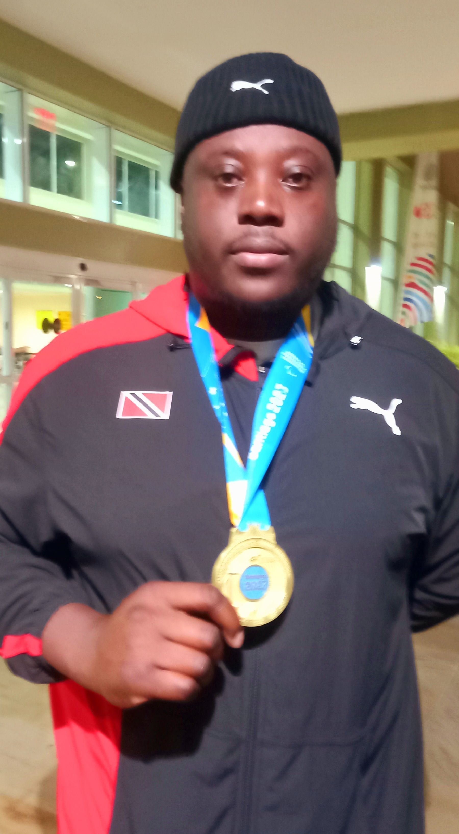 T&T'S Akeem Stewart displays his gold medal on his return home yesterday morning. Stewart won the men's F 64 discus title at the 2023 Para-Pan American Games in Santiago, Chile on November 24.  Clayton Clarke (Image obtained at guardian.co.tt)